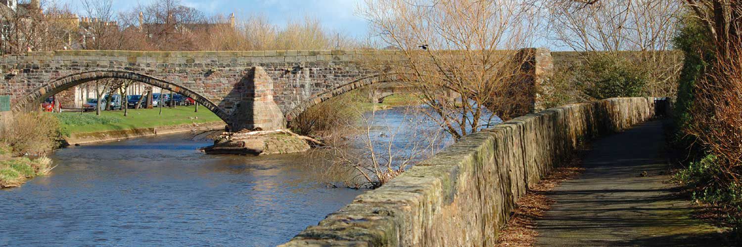 A stone bridge in Musselburgh on a sunny day