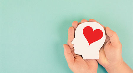 Image of a hand holding a head with a heart on it