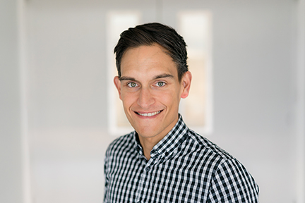 headshot of Joseph McIntyre wearing a black and white checked shirt