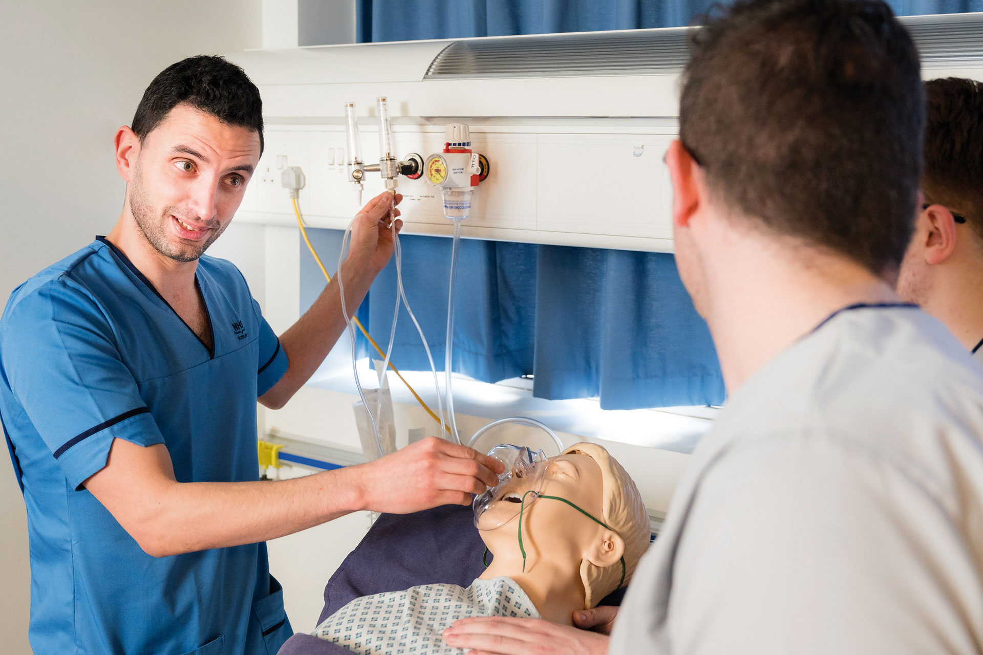 Photo of Male Nurse demonstrating Oxygen Usage on a Dummy within the Nursing Simulation Suite