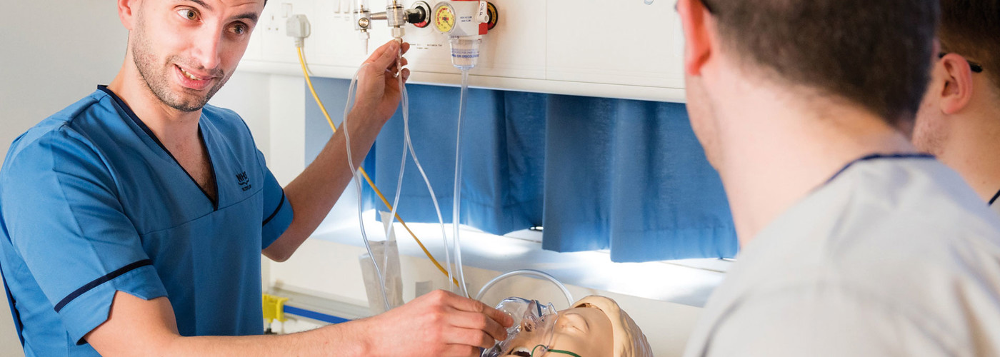 Photo of Male Nurse demonstrating Oxygen Usage on a Dummy within the Nursing Simulation Suite