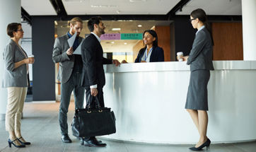 Business people standing at a hotel reception