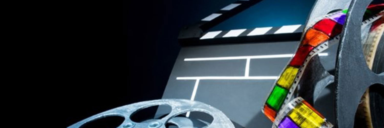 Assorted film equipment, including a roll of film in rainbow colours