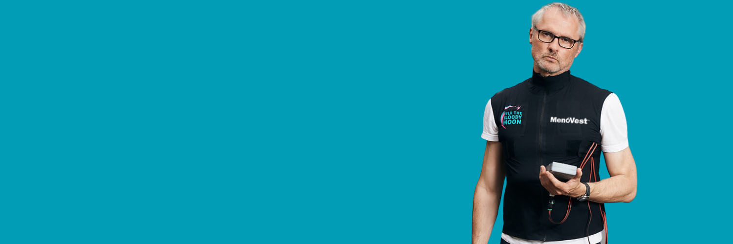 A man wearing a MenoVest Menopause simulator vest.