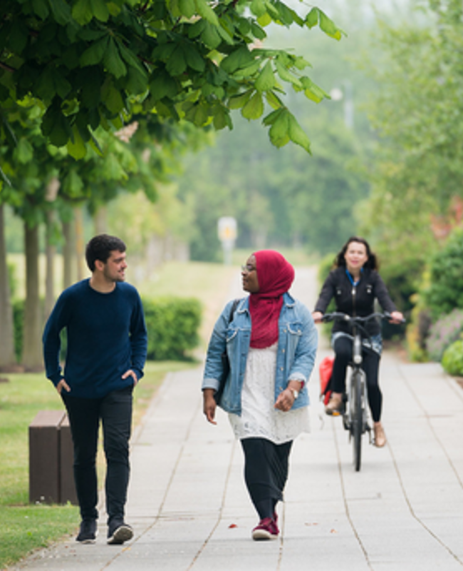 Students walking and cycling on the QMU campus