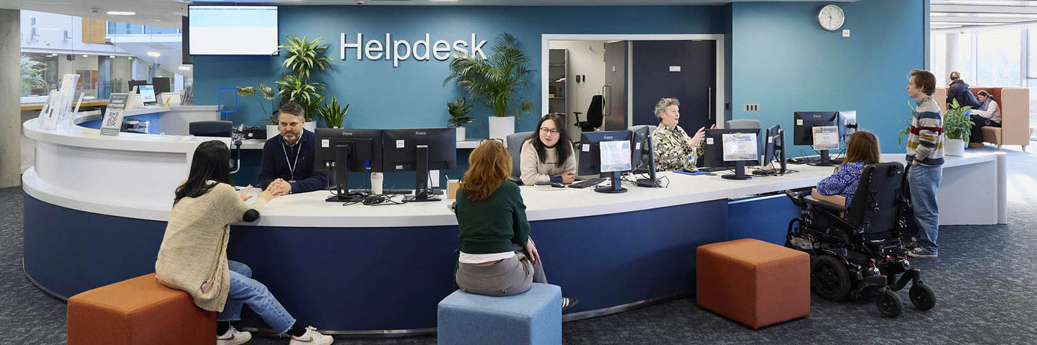 Several students speaking to staff members at the LRC Helpdesk