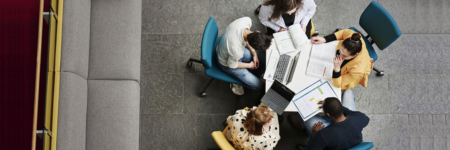A group of business students sat around a desk