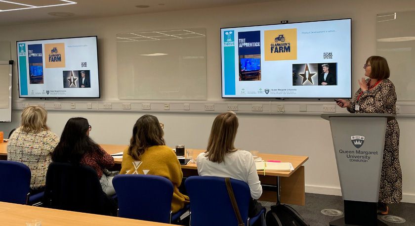 A person presenting on product development to an audience