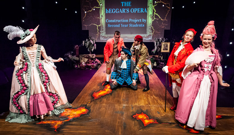 Students on stage in costumes