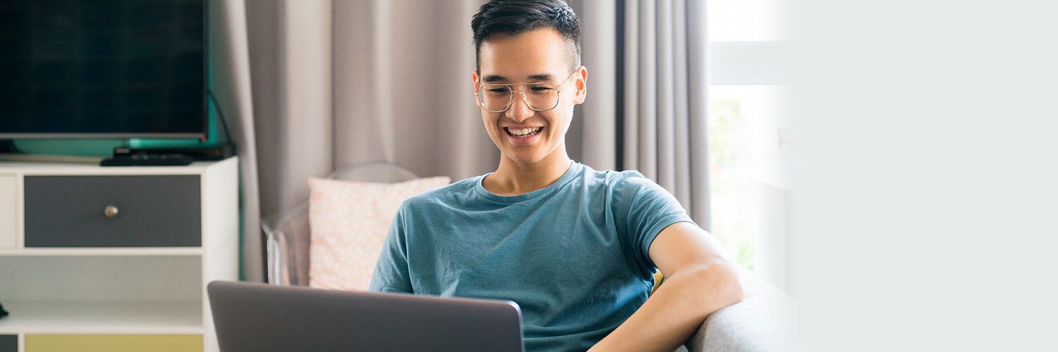 smiling prospective student working on laptop