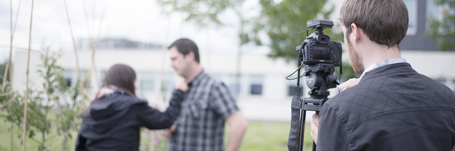 QMU students outside with a professional camera