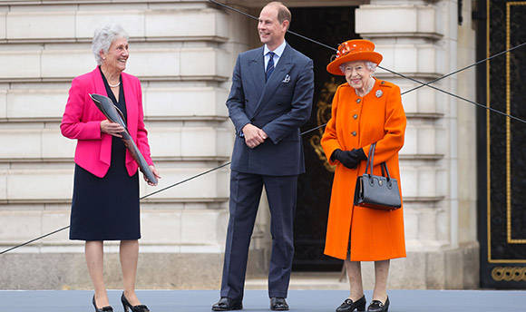 Photo of Dame Louise Martin with Prince Edward, now Duke of Edinburgh, and Queen Elizabeth II.