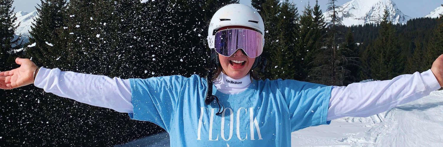 Student wearing snowboarding helmet on snowy mountain