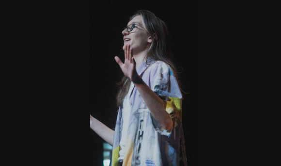 Graduate James Wood performing on stage