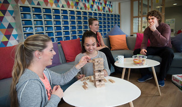 A group of students playing jenga.