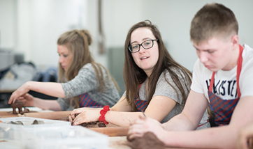 Students building clay models