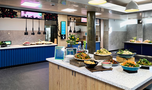 Guthrie's restaurant in Queen Margaret University, Edinburgh. In focus is the salad bar, filled with a variety of fresh ingredients.