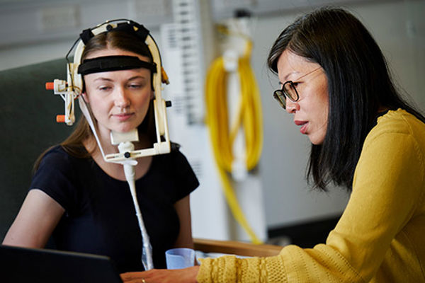 Two people using ultrasound technology to measure swallowing capability.