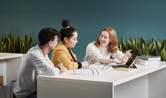 Colleagues sitting looking at data and chatting
