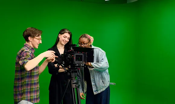 Students using a camera and green screen