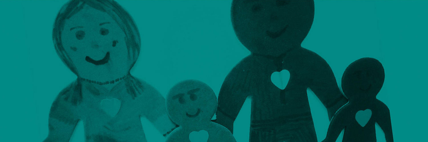 B+W photo of a child's drawing of a family with hearts on their chests