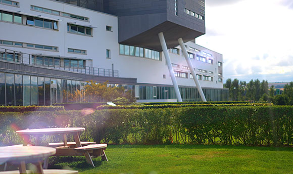 Dining tables at QMU Terraces with QMU main building in backdrop