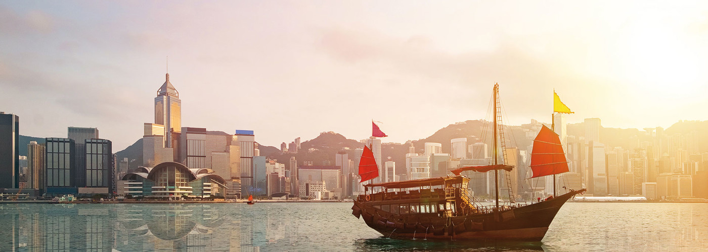 Beautiful photo of red junk boat with Hong Kong skyline
