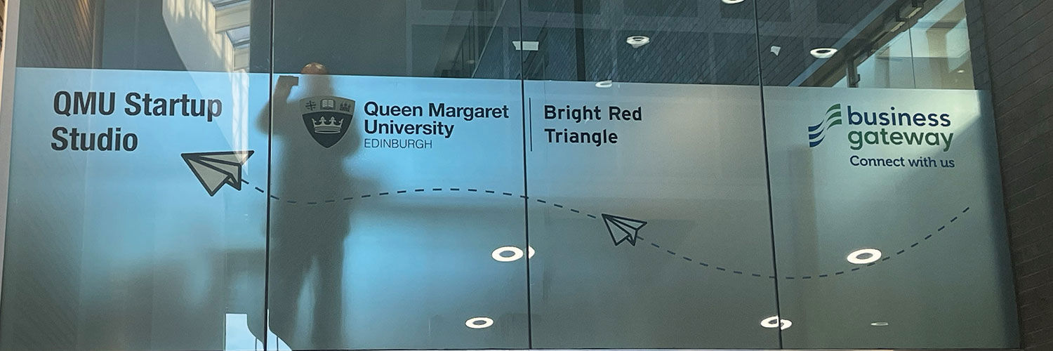 The glass walls of the Startup Studio on QMU Campus