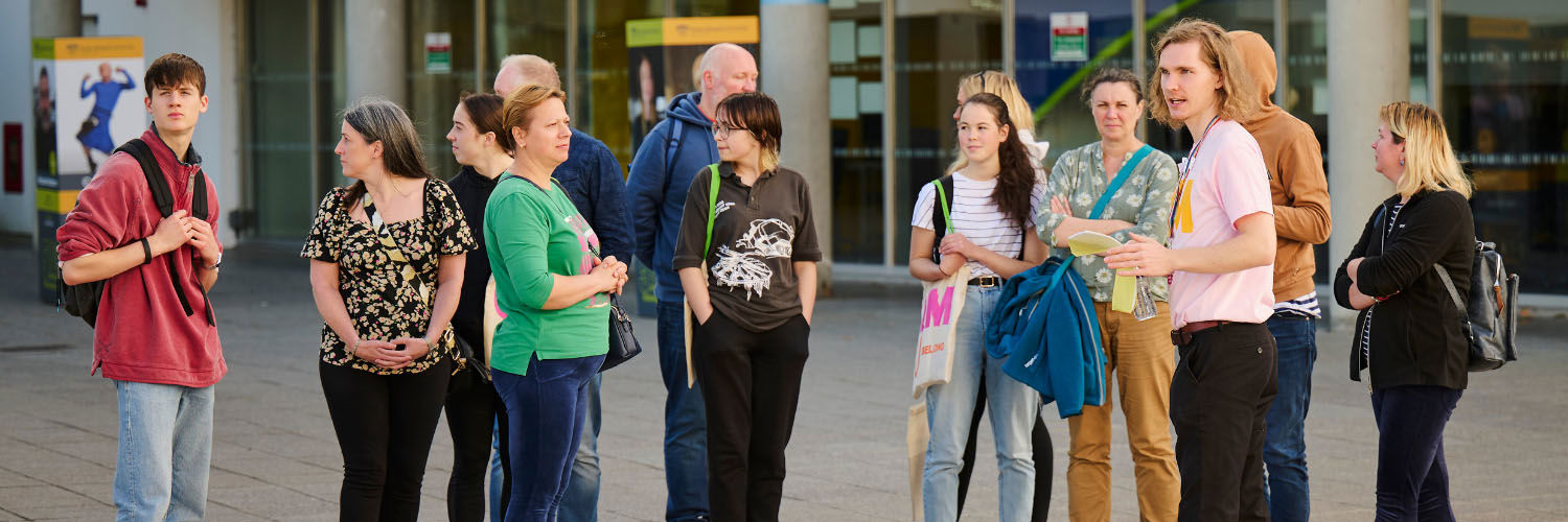 A group of people attending an Open Day event at Queen Margaret University campus.