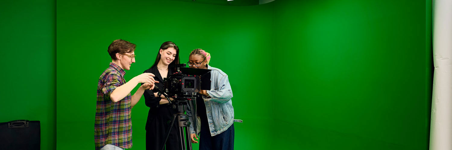 Students using a camera and green screen