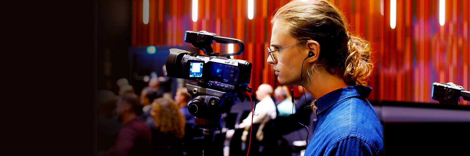 David Blomquist filming in a busy event