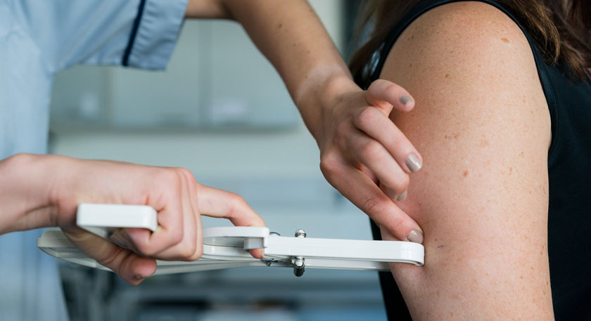 Image of someone's arm being measured