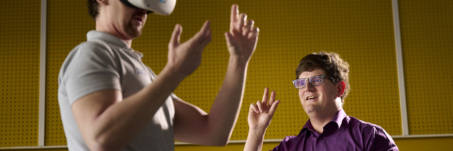 Lecturer guides student through VR simulation