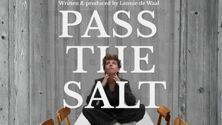 Poster for Pass the Salt, showing a person sitting cross-legged on a dining table beneath the large white title text.