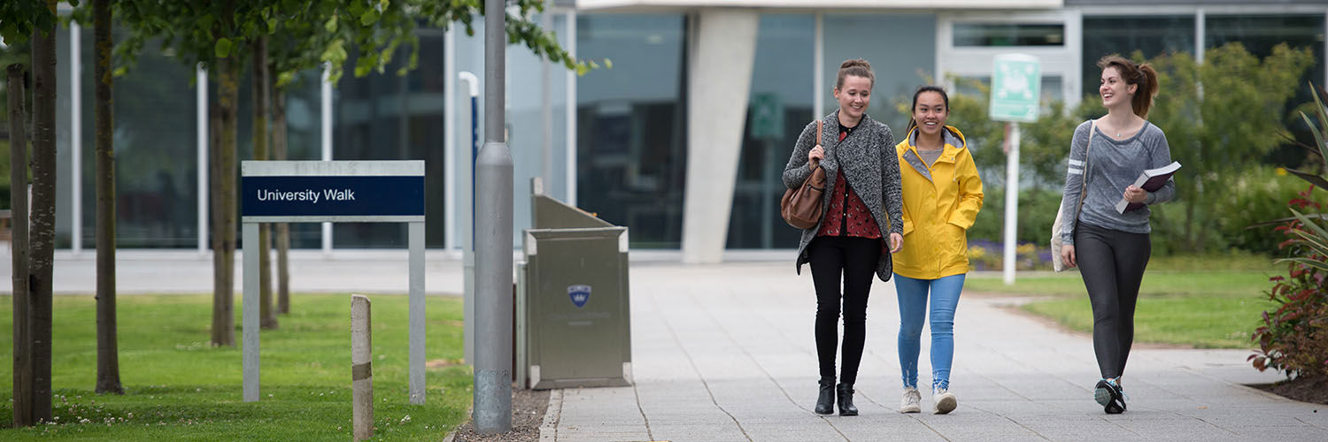 A group of happy QMU students walking on campus