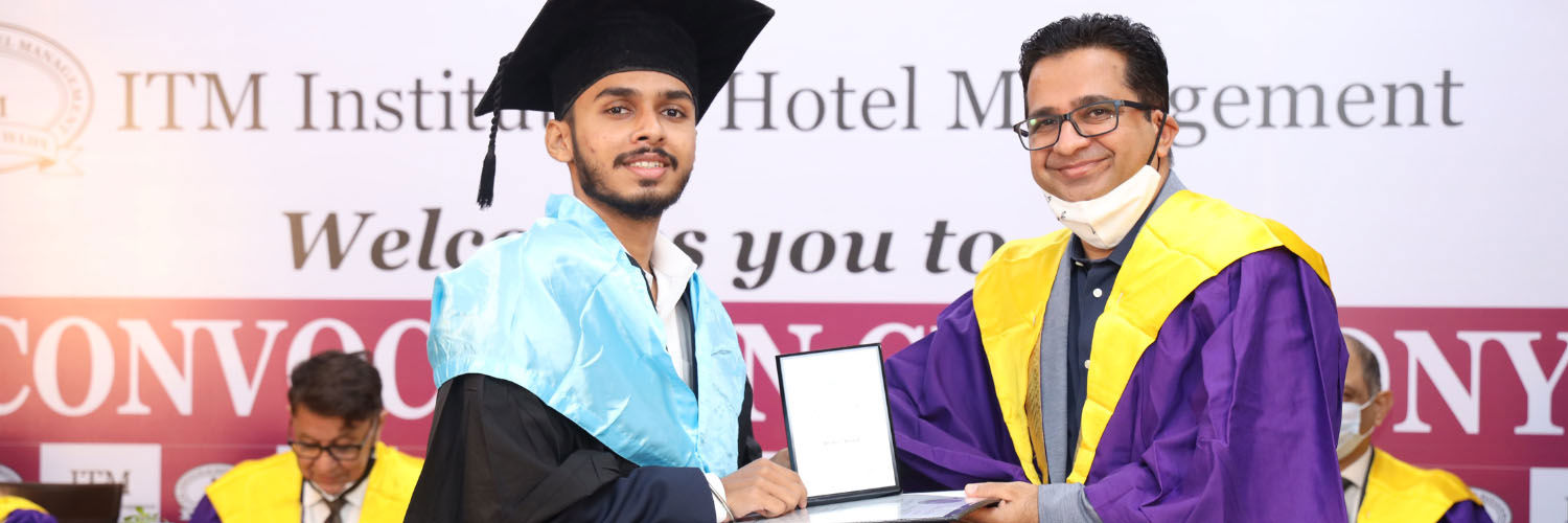 QMU/ITM graduate Atharva Gurav receives his degree certificate.