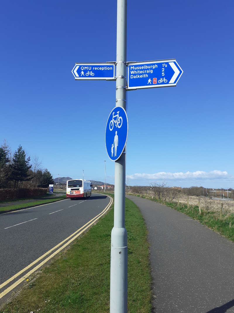 Street post with directions to campus and National cycle route information