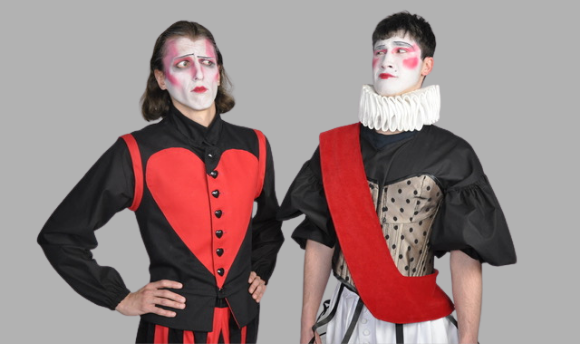 Two men wearing theatrical red and black costumes with white faces and make up