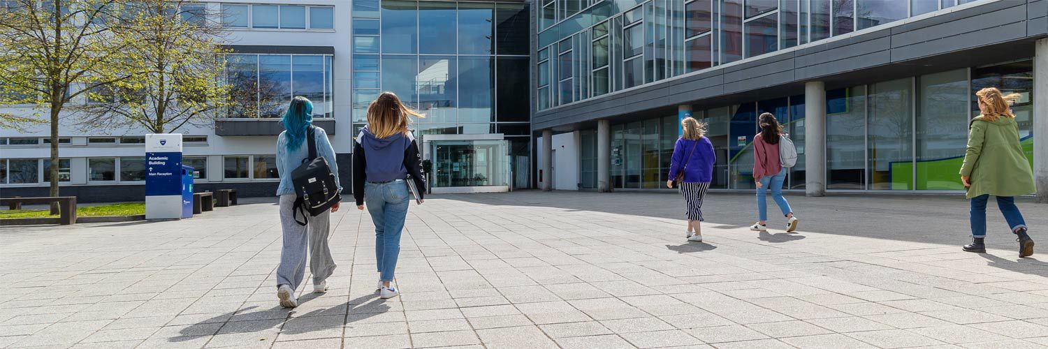 A group of students walking into QMU campus