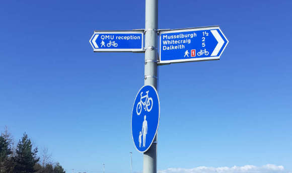 Street post with directions to campus and National cycle route information