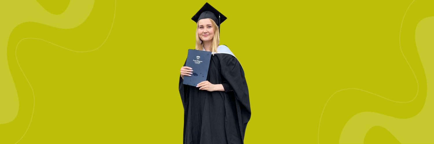 QMU student Neea Nieminen at graduation holding her diploma