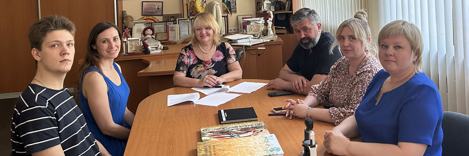 Group of university staff sitting around board room table
