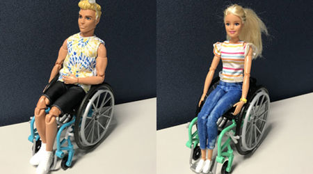 A collage image of a Ken doll and a Barbie doll, both seated in wheelchairs.