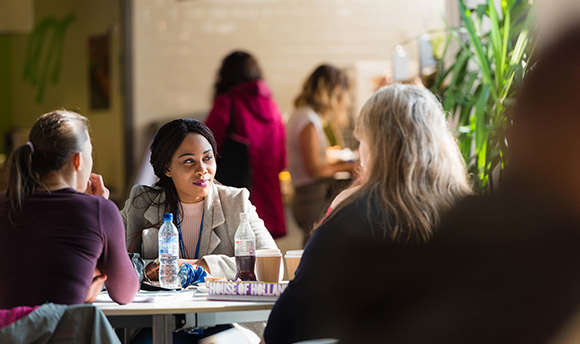 Female sitting chatting with fellow students