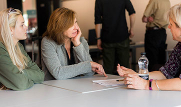 Student and parent discussing complaint with university staff 