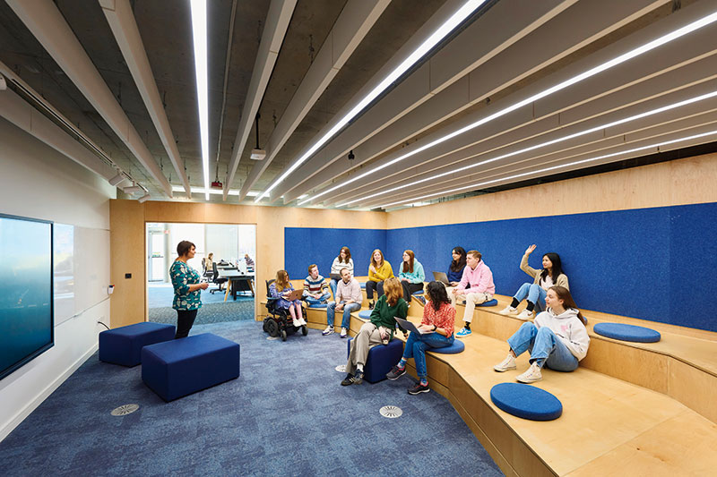 Photo of Lecturer presenting to students in one of our new study spaces