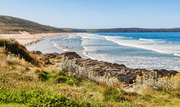 A view of the coastline from atop a rocky cliff edge