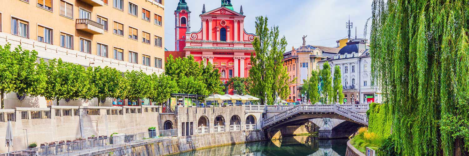 A picturesque view of a canal in a city centre within Slovenia.