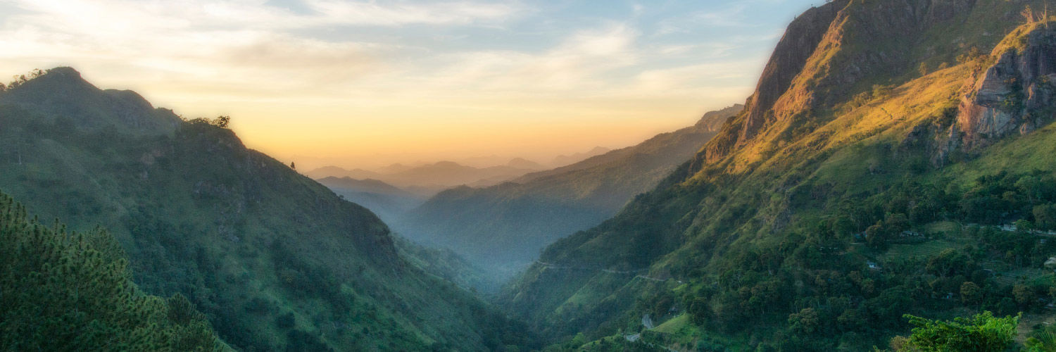 A beautiful mountain range in Sri Lanka with the sun setting over the lower hills