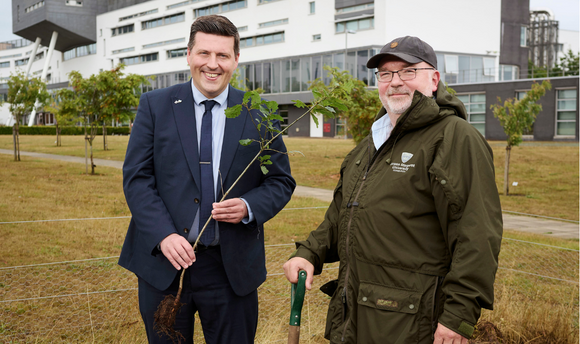 Minister for higher education Jamie Hepburn and QMU lecturer Patrick Boxall plant an oak tree in the University's Wee Forest.